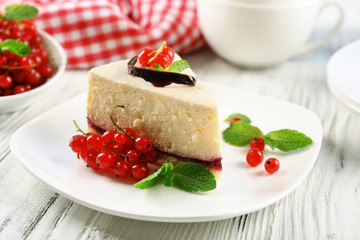 Delicious cheesecake with berries on table close up