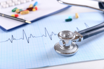 Stethoscope on cardiogram  sheet, closeup