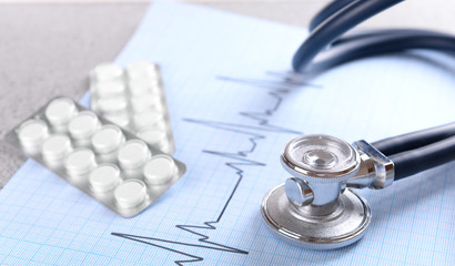Stethoscope on cardiogram  sheet, closeup