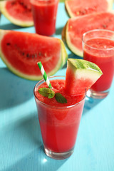 Glass of watermelon juice on wooden table, closeup