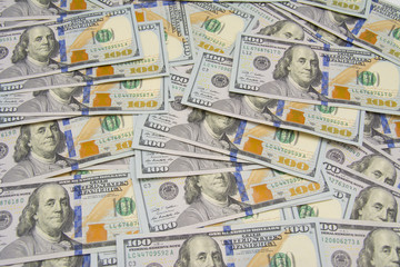 One hundred dollars pile as background