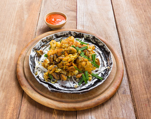 Crisp fried mussel pancake on wood