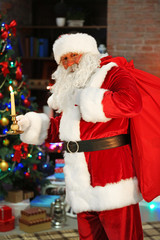 Santa Claus with candle Christmas interior background
