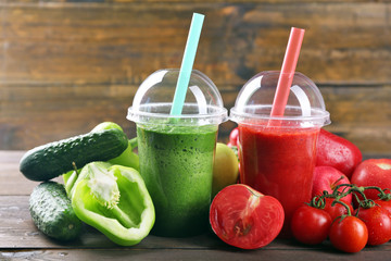 Fresh juice mix fruit, healthy drinks in plastic cups on wooden background