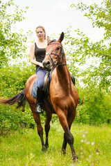 Woman jockey training riding horse. Sport activity