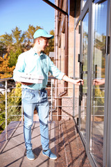 Pizza delivery boy holding boxes with pizza, outdoors