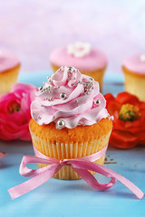 Tasty cupcakes on tray, on light background