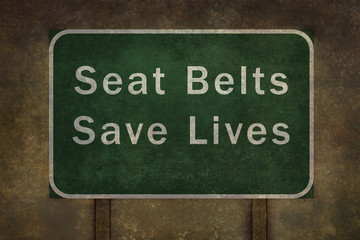 "Seat belts save lives" roadside sign illustration