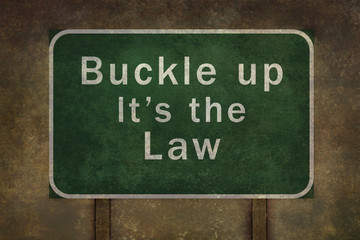 "Buckle up its the law" roadside sign illustration