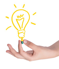 Drug capsule in hand with light bulb ,Idea concept