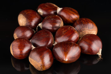 Chestnuts on a black reflective background