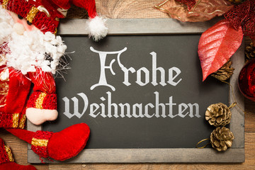 Blackboard with the text: Happy Christmas (in German) in a conceptual image