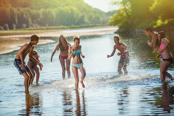 Young people having fun at the beach during a summer day. 