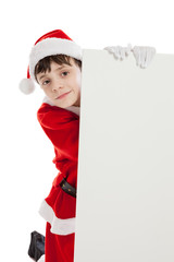 Boy dressed as Santa holding blank sign