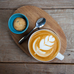 cup of coffee and cookie in coffee shop vintage color