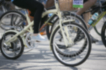 Fototapeta na wymiar bicycle wheel detail with blurry cyclist