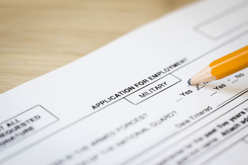 horizontal close up image of a job application for the military department .