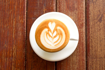 Hot coffee in a white cup on table