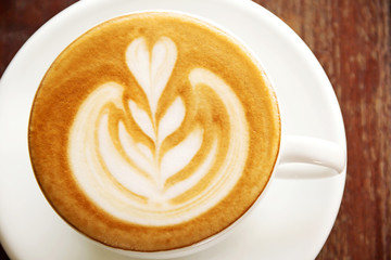 Hot coffee in a white cup on table