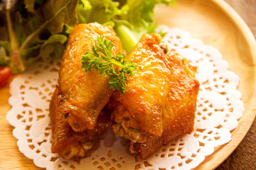 chicken wings with vegetables on wooden table