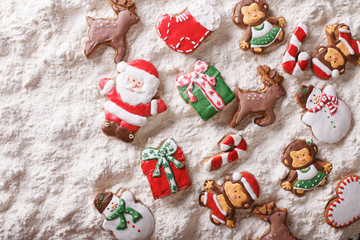 Christmas gingerbread on white flour background. Horizontal top view
