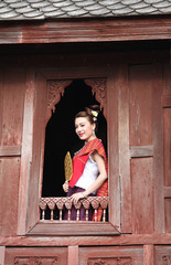 Beautiful Thai woman at window