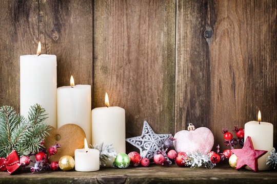 Christmas Advent candles with festive decor.