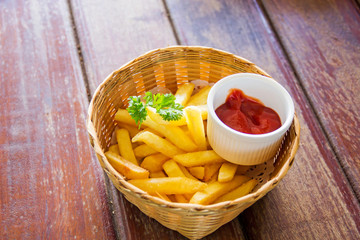 Traditional French fries with ketchup on table