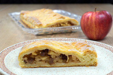 Homemade strudel with walnuts and apple on a plate