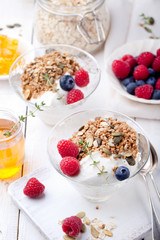 Healthy breakfast. Granola with pumpkin seeds, honey, yogurt, fresh berries .