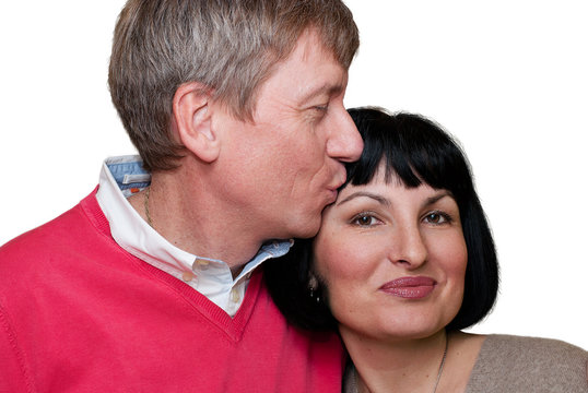 Middle Aged Couple Kissing On White Background