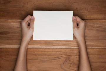 Fototapeta premium A female(woman) hand hold(open) a envelope and post card on the