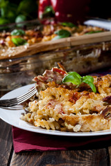 Portion of fusilli pasta casseroles, sausages and zucchini