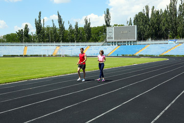Young people jogging on stadium