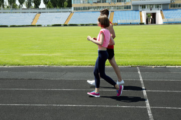 Young people jogging on stadium