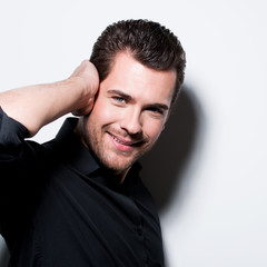Naklejka premium Portrait of attractive smiling man in black shirt.