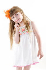 the young girl on the white dress  posing and pointing hand for the camera showing funny faces isolated on the white background