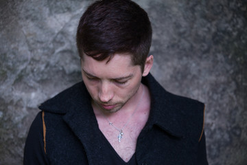 Portrait of a Man on the background of gray-green concrete wall