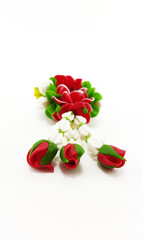 Small Polymer Clay Garland Of Flowers on white background; Selec