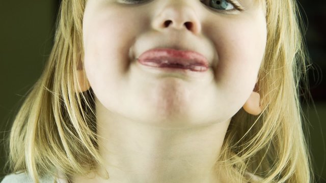 The little cute girl puts out the tongue in the camera