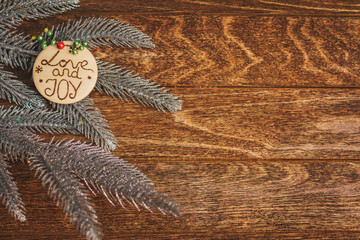 Christmas tree with burned inscription Love and Joy on wood text
