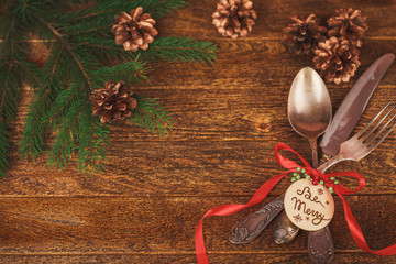 Christmas table place setting with christmas pine branches, ribb