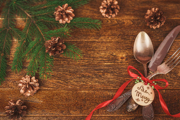 Christmas table place setting with christmas pine branches, ribb