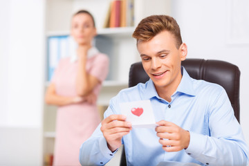 Fototapeta premium Male executive looks delighted while reading the note.