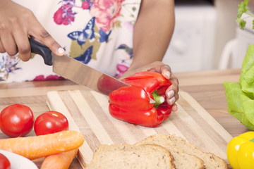 Young lady chopping vegetables