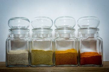 White yellow orange and red ingredients on the wooden shelf