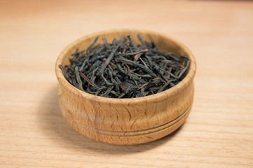 black tea in a wooden bowl