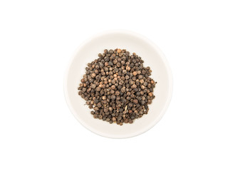 Black peppercorn in white bowl over white background