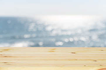 Empty wooden table and blurred cafe or restaurant with bokeh bac