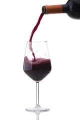 Fototapeta na wymiar red wine poured into the glass on white